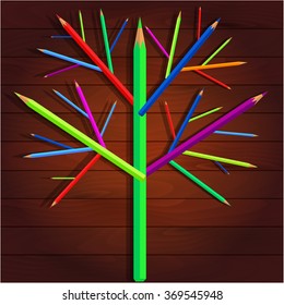 Tree of bright crayons on a wooden background