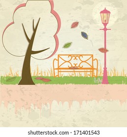 a tree, chair and a lamp in a park