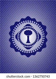 tree icon inside badge with denim texture