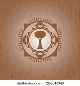 tree icon inside badge with wood background