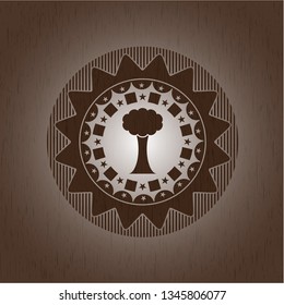 tree icon inside badge with wooden background