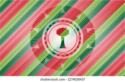 tree icon inside christmas colors badge.