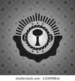 tree icon inside dark emblem