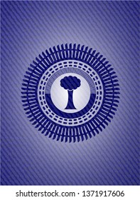 tree icon inside emblem with jean background