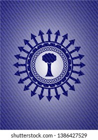 tree icon inside emblem with jean background