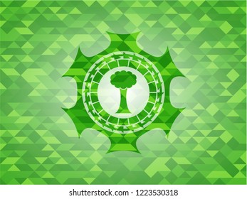 tree icon inside green emblem with mosaic background