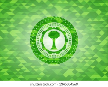 tree icon inside green emblem. Mosaic background