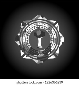 tree icon inside grey camouflage emblem