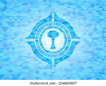 tree icon inside light blue emblem with triangle mosaic background