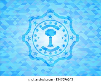 tree icon inside light blue emblem with mosaic background