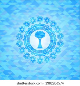 tree icon inside light blue mosaic emblem