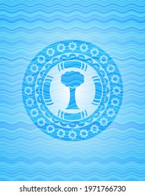 tree icon inside light blue water badge background. 