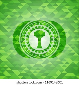 tree icon inside realistic green mosaic emblem