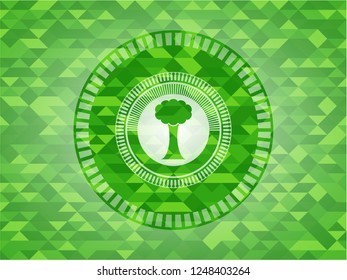 tree icon inside realistic green mosaic emblem