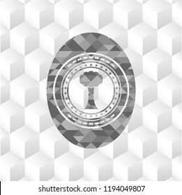 tree icon inside realistic grey emblem with geometric cube white background