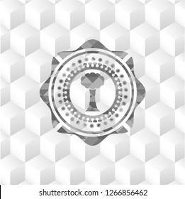 tree icon inside realistic grey emblem with geometric cube white background