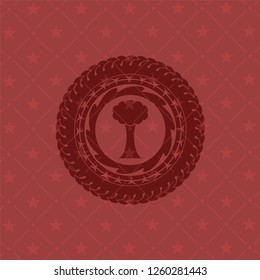 tree icon inside red emblem