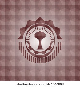 tree icon inside red seamless emblem with geometric background.