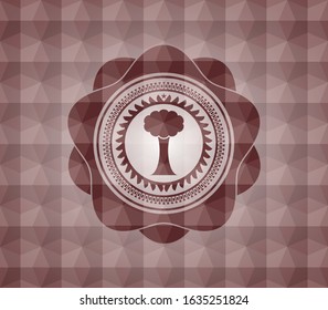 tree icon inside red seamless emblem with geometric background.