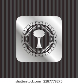 tree icon inside silver emblem or badge. 