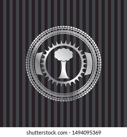 tree icon inside silvery badge or emblem