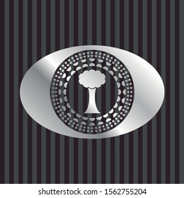 tree icon inside silvery badge or emblem