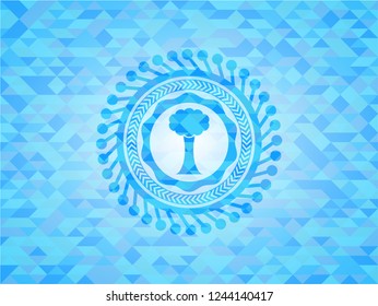 tree icon inside sky blue emblem. Mosaic background