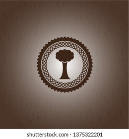 tree icon inside wood badge or emblem