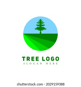 tree logo in vintage style. logo with the concept of a large tree and grass field