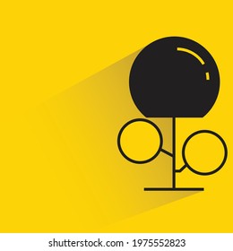 tree with shadow on yellow background