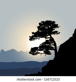 Tree Silhouette On A Mountain Background