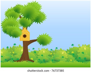 A tree standing on a green meadow with a house for birds