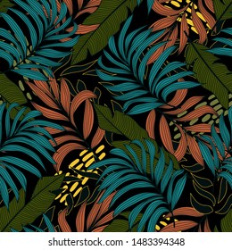Trend seamless pattern with colorful tropical leaves and plants on black background. Vector design.Exotic tropics. Summer. Jungle print. Floral background. Printing and textiles. Abstract background.