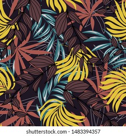 Trend seamless pattern with colorful tropical leaves and plants on a dark background. Vector design.Exotic tropics. Summer. Jungle print. Floral background. Printing and textiles. Abstract background.