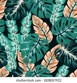 Trend seamless pattern with colorful tropical leaves on a dark background. Creative abstract background. Exotic wallpaper, Hawaiian style. Jungle leaves. Botanical pattern.
