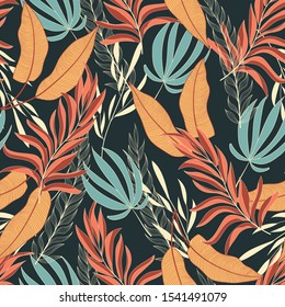 Trend seamless tropical pattern with bright yellow and red plants and leaves on dark background. Beautiful exotic plants.  
Jungle leaf seamless vector floral pattern background.