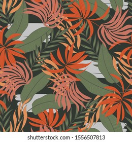 Trend seamless tropical pattern with bright orange and yellow plants and leaves on a green background. Modern abstract design for fabric, paper, interior decor. Tropical botanical.