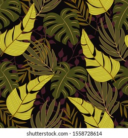 Trend tropical seamless background with bright yellow and green plants and leaves on black background. Seamless pattern with colorful leaves and plants. Beautiful print with hand drawn exotic plants.