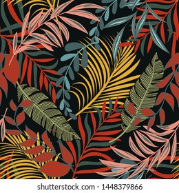 Trending abstract seamless pattern with colorful tropical leaves and plants on black background. Vector design. Jungle print. Floral background. Printing and textiles. Exotic tropics. Fresh design.