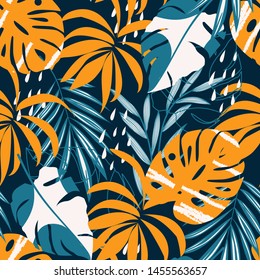 Trending abstract seamless pattern with colorful tropical leaves and plants on a dark background. Vector design. Jungle print. Floral background. Printing and textiles. Exotic tropics. Fresh design.