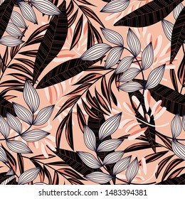 Trending abstract seamless pattern with colorful tropical leaves and plants on pink background. Vector design. Jungle print. Floral background. Printing and textiles. Exotic tropics. Summer.