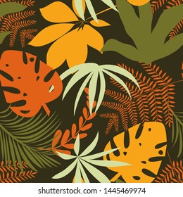 Trending bright seamless background with colorful tropical leaves and plants on green background. Vector design. Jungle print. Floral background. Printing and textiles. Exotic tropics. Fresh design.
