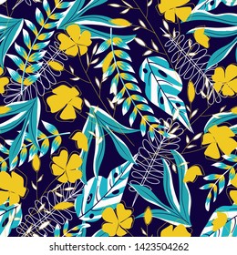Trending bright seamless pattern with tropical leaves, plants and flowers on purple background. Vector design. Jungle print. Floral background. Printing and textiles. Exotic tropics. Summer design.