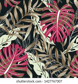 Trending seamless background with bright tropical leaves and plants on black background. Vector design. Jungle print. Floral background. Printing and textiles. Exotic tropics. Summer design.