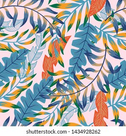 Trendy abstract seamless pattern with colorful tropical leaves and flowers on a gentle background. Vector design. Jungle print. Floral background. Printing and textiles. Exotic tropics. Summer design.