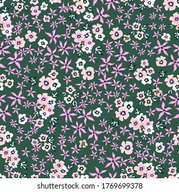 Trendy floral pattern on green background. Vintage print with small inflorescences. Seamless vector pattern. Retro textile collection.