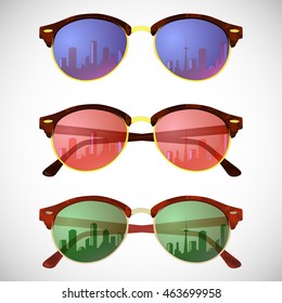 Trendy hipster sunglasses with colorful lens and frame reflect city sky view in summer