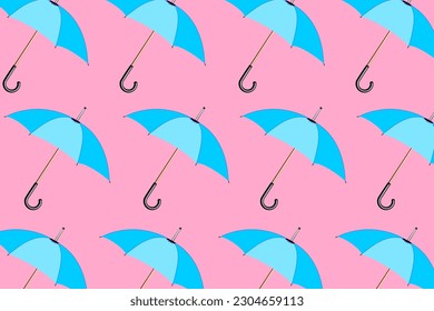 Trendy pattern with umbrellas. A set of modern blue umbrellas on a pastel pink background