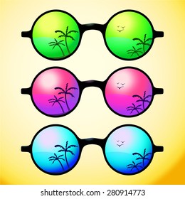 Trendy, round and vintage sunglasses with colorful lens reflect summer palms