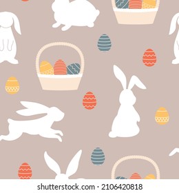 Patrón moderno y sin fisuras con siluetas de conejos, cestas y huevos de colores. Diseño de primavera de Semana Santa con conejitos. Fondo del vector